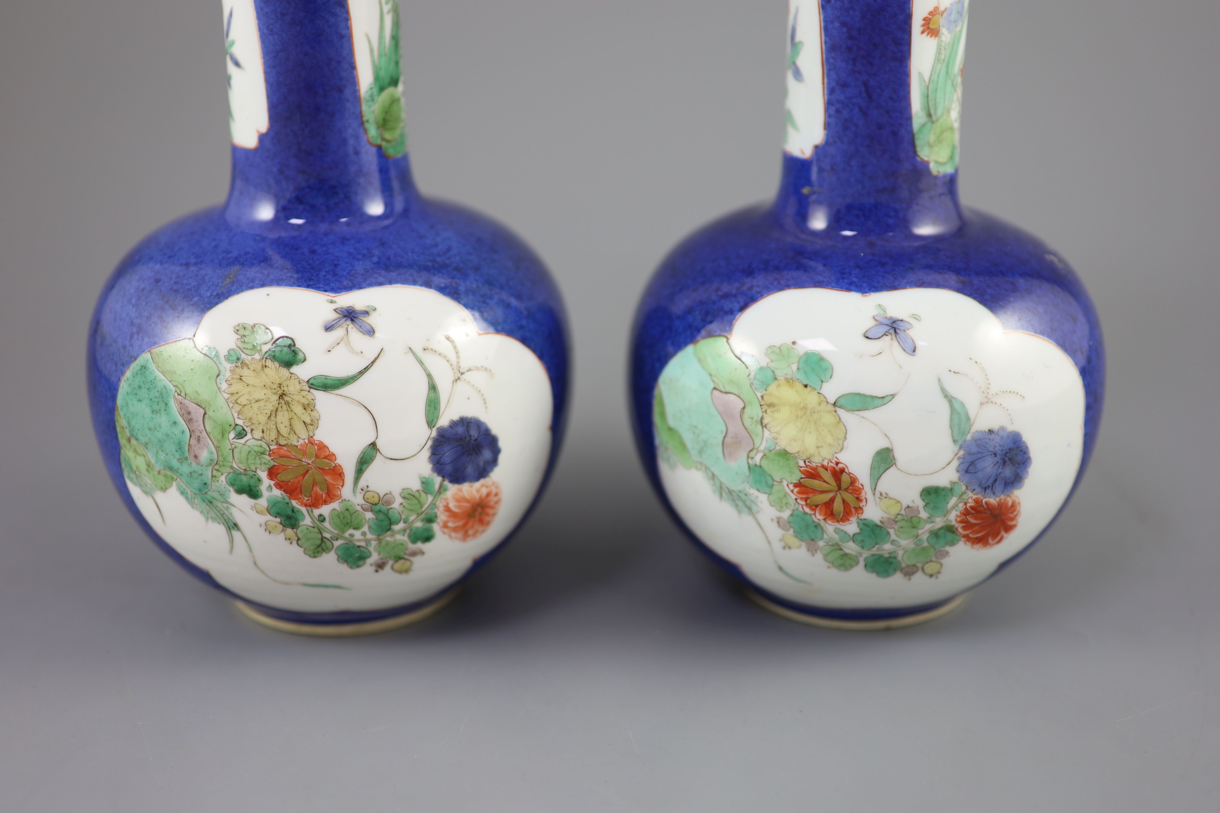 A pair of Chinese powder blue famille verte bottle vases, Kangxi period (1662-1722), 26cm high
